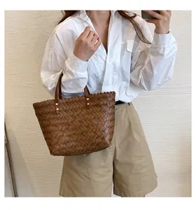 Detail view of a stylish brown woven leather tote handbag for women, casual daily wear.