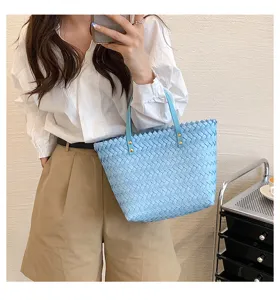 Blue woven tote bag for women, chic stylish handbag with top handles for daily wear.