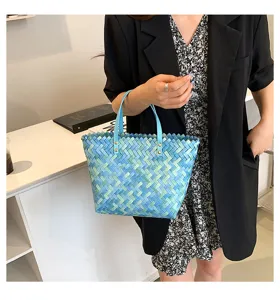 Detailed view of a stylish blue gradient woven tote bag, perfect for daily casual spring looks.