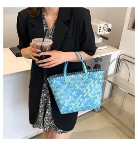 Woven straw tote bag detail showing fine blue texture and dual handles for women daily style.