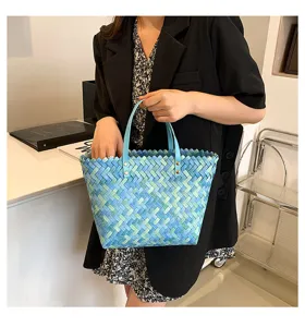 Stylish blue woven tote bag for women, chic hand-held casual shopper bag for daily wear.