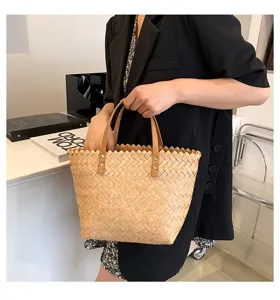 Woven straw handbag for women, chic leather handles and metal rivet details, stylish daily bag.