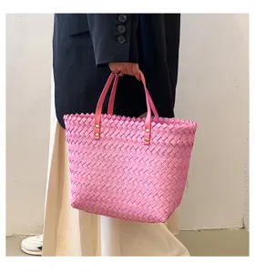 Pink woven straw tote bag for women, stylish casual shoulder shopping bag for spring daily use.