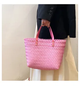 Stylish pink woven tote bag for women, perfect casual handbag with double handles and chic design.