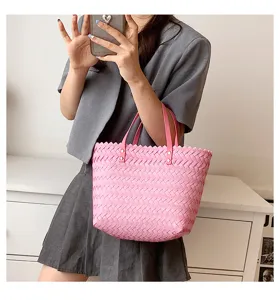 Pink woven tote bag detail view, chic casual shoulder handbag with pink leather handles.