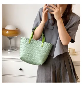Light green woven tote bag for women, stylish straw handbag with leather handles for daily use.