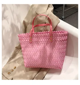 Pink woven tote bag detail showing texture, stylish women shoulder shopping bag for daily use.