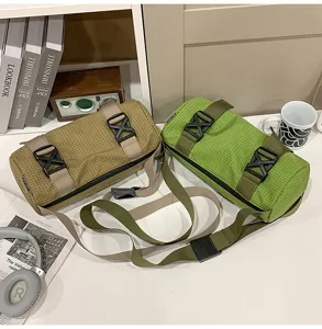Casual grid cylinder crossbody bag, stylish neutral shoulder bag for sports and travel.