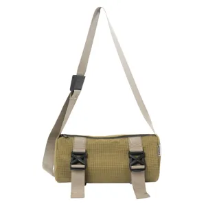 Detailed view of the khaki grid cylindrical crossbody bag with dual buckles and strap.