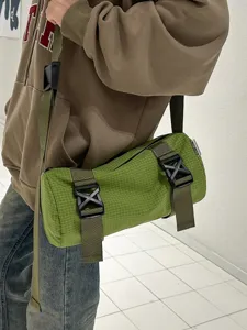 Casual green grid cylinder crossbody bag, stylish unisex shoulder bag for travel.