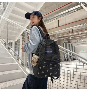 Large capacity student backpack with contrast stripes and denim star pattern for daily use.