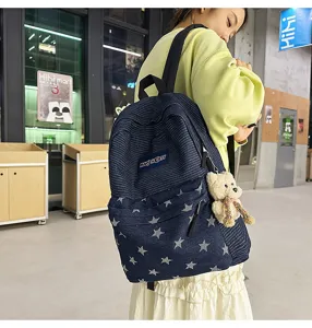 Stylish corduroy denim backpack with star pattern and bear pendant, large capacity for student use.