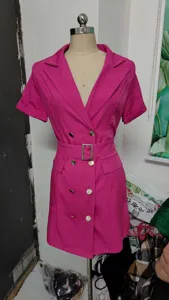 Detailed view of the pink short sleeve blazer dress featuring double breasted buttons and belt.