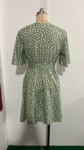 Green short sleeve V-neck waist-cinching dress with abstract white dot print for women.