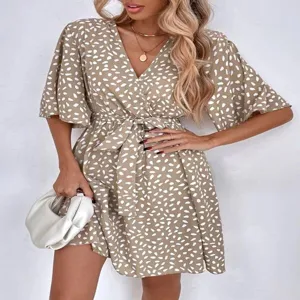 Chic V-neck short sleeve wrap dress with elegant polka dot print and waist tie design for women.