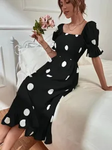Detail view of women black and white polka dot dress featuring elegant square neck and puff sleeves.