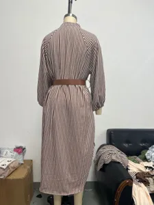 Detail back view of a stylish brown and white striped long sleeve midi dress with a belt.
