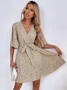 Khaki V-neck short sleeve wrap dress featuring white abstract dot print and waist belt.