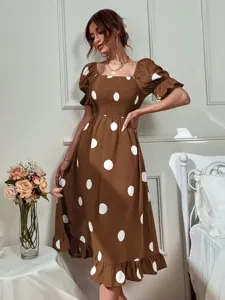 Brown polka dot dress detail, featuring a stylish square neckline, short ruffled sleeves, and smocked bodice.