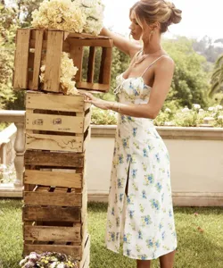 Outdoor summer floral slit dress detail showing elegant style with charming blue and yellow flowers.