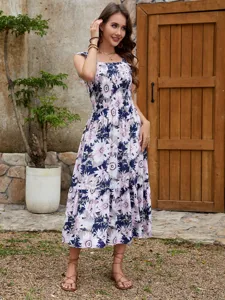 Close-up details showcasing the vibrant floral print and ruffle sleeves of this summer dress.