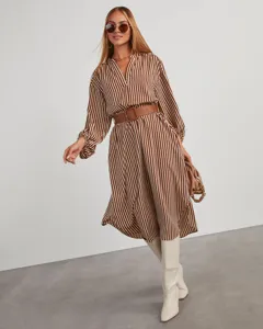 Detailed view of stylish brown and white striped shirt dress with belt and boots.