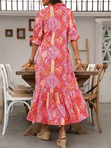 Back view of women bohemian floral printed midi dress with ruffled hem and half sleeves.