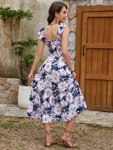 Stunning floral print tiered midi dress featuring a chic smocked bodice and ruffled cap sleeves.