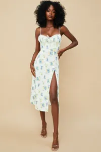 Detail shot of the floral spaghetti strap midi dress featuring a stylish front slit and sweet tie.