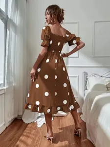Detailed view of the brown polka dot midi dress featuring a square neck and puff sleeves.
