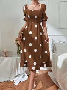 Brown polka dot dress detail showcasing the square neckline, puff sleeves, and ruffled hem.