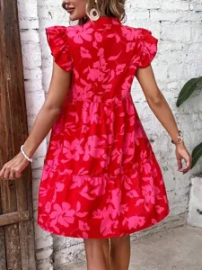 Back view detail of a red floral print short sleeve ruffle dress with tiered hem line design.