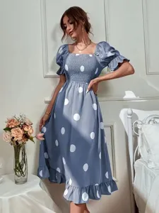 Blue polka dot midi dress featuring square neck, smocked bodice, and cute puff sleeves.