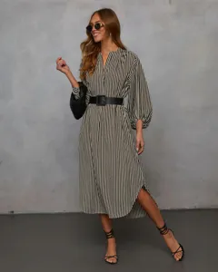 Detail view of a stylish black and white striped midi shirt dress with long sleeves and belt.