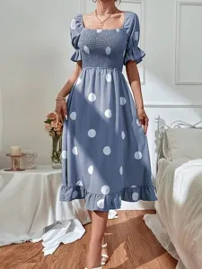 Blue polka dot midi dress with square neck, smocked bodice and short ruffled sleeves.