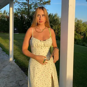 Detailed view of the yellow floral camisole dress with front slit, perfect for summer outdoor style.