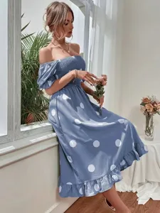 Detail view of a blue off-shoulder polka dot midi dress with smocked bodice and ruffled hem.