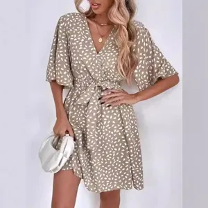 Chic V-neck short sleeve wrap dress with stylish splatter print and waist belt for women.