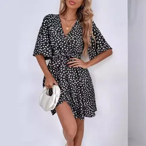 Chic black and white polka dot V-neck short sleeve waist-cinching casual dress for women.