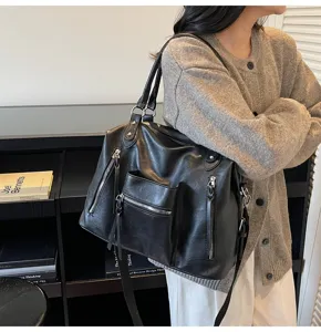 Grote zwarte PU lederen schoudertas casual reistas tote bag met meerdere ritsvakken.