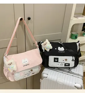 Cute color-blocking canvas messenger shoulder bag for students girls with cute cat plush decor.