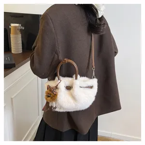 Chic autumn winter white plush pleated bucket bag with brown handle and cute charm detail.