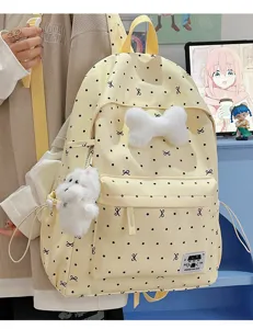Süßer gelber Pünktchen Schulrucksack mit flauschiger Schleife und Welpenanhänger.