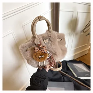Close-up detail of the fuzzy plush crossbody bag featuring a cute animal plush charm & strap.