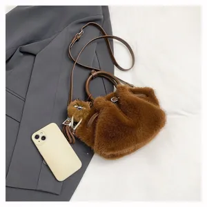 Detailed shot of the brown plush pleated bucket bag with soft fabric, top handle and strap.