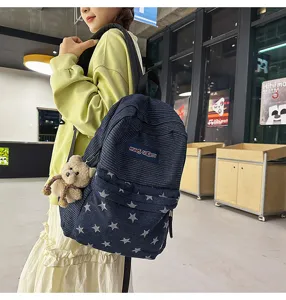 Detailed view of stylish star pattern corduroy denim school backpack for student daily use.