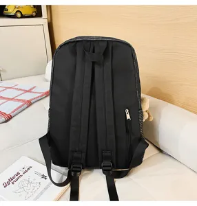 Black denim striped school backpack back view showing adjustable straps and zipper pocket.