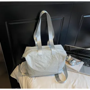 Minimalist large capacity nylon tote bag detail shot, casual shoulder crossbody travel bag.