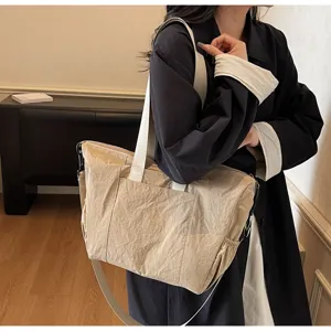 Casual minimalist large capacity khaki tote bag, shoulder and crossbody lifestyle detail view.