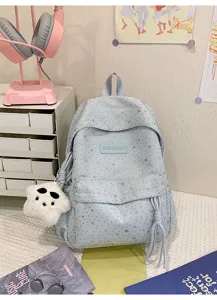 Sac à dos d'écolier bleu clair avec motif d'étoiles argentées et pendentif pour fille.